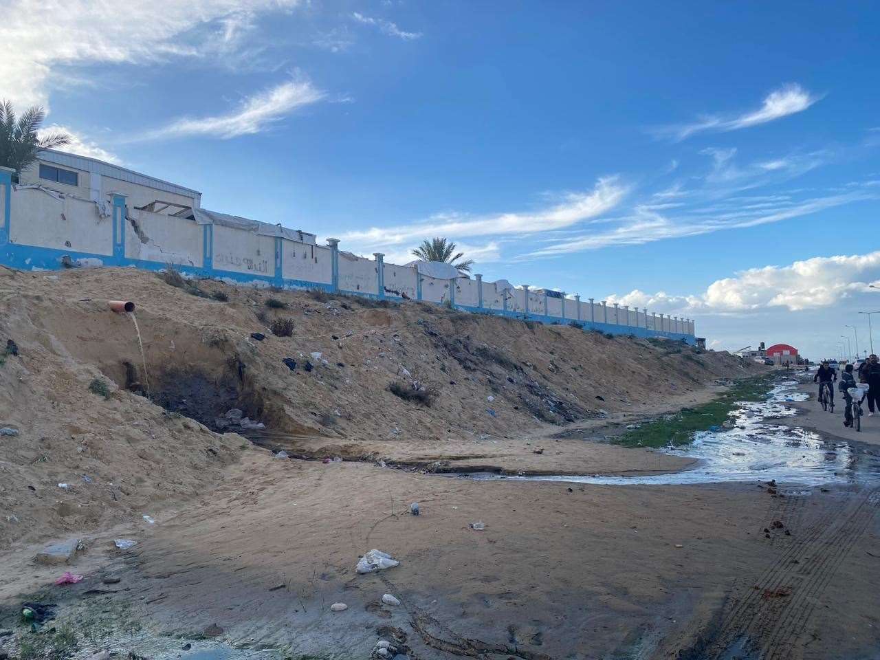 Sewage spillage on a street in Gaza (Mohammed Ghalayini/PA)