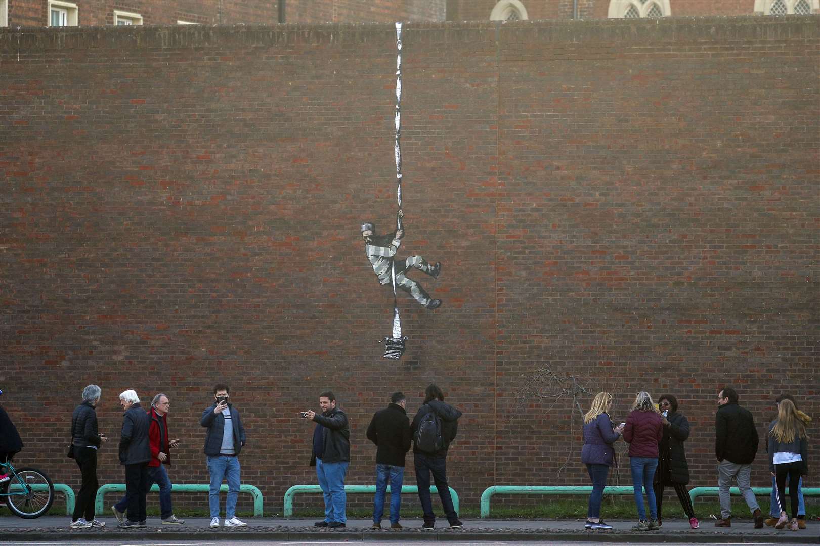 Crowds gather to study the piece (Steve Parsons/PA)