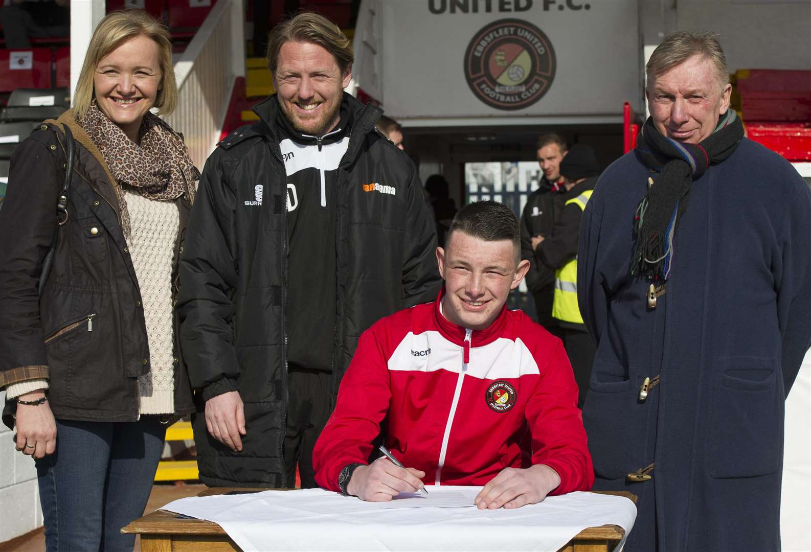 Joe Denny, flanked by mum Hayley and dad Ray, along with then Ebbsfleet manager Jamie Day, signs his first professional contract at Stonebridge Road in 2015. Picture: Andy Payton