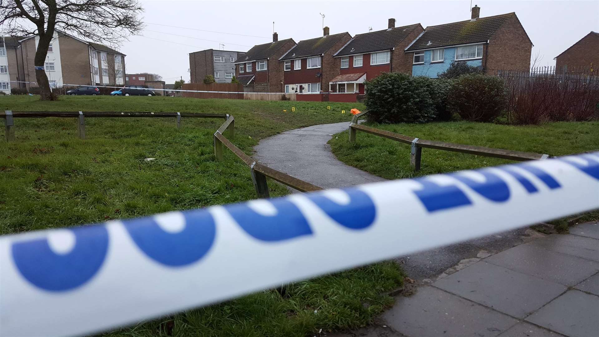 Police taped off a grassy area at the rear of the Brookfield Road shopping precinct