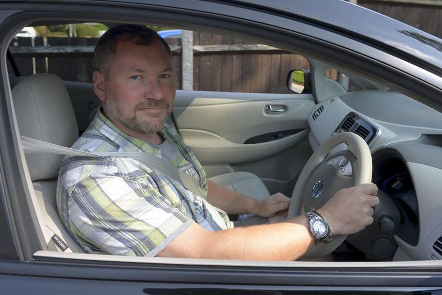 Darren Bramley behind the wheel of his electric car