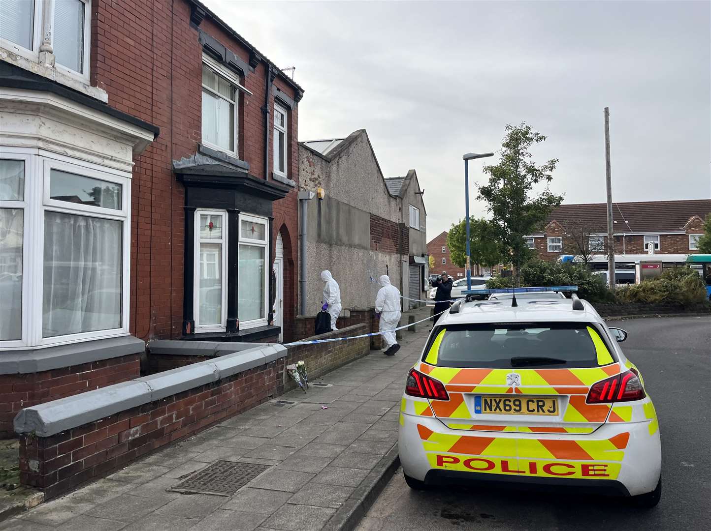 Two forensics officers enter a cordoned-off property in Wharton Terrace, Hartlepool (Tom Wilkinson/PA)