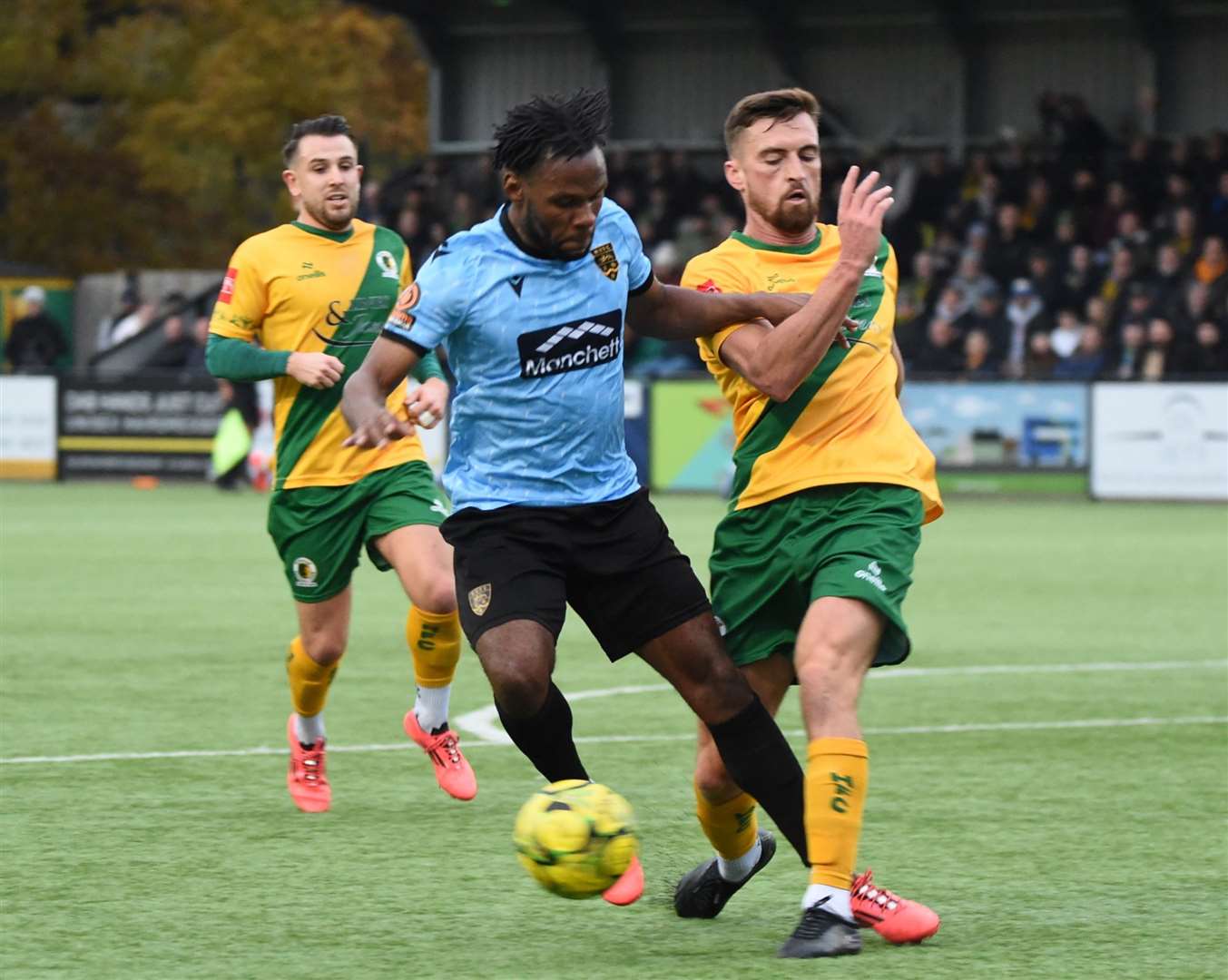 Maidstone striker Shaq Coulthirst is challenged by a Horsham defender. Picture: Steve Terrell