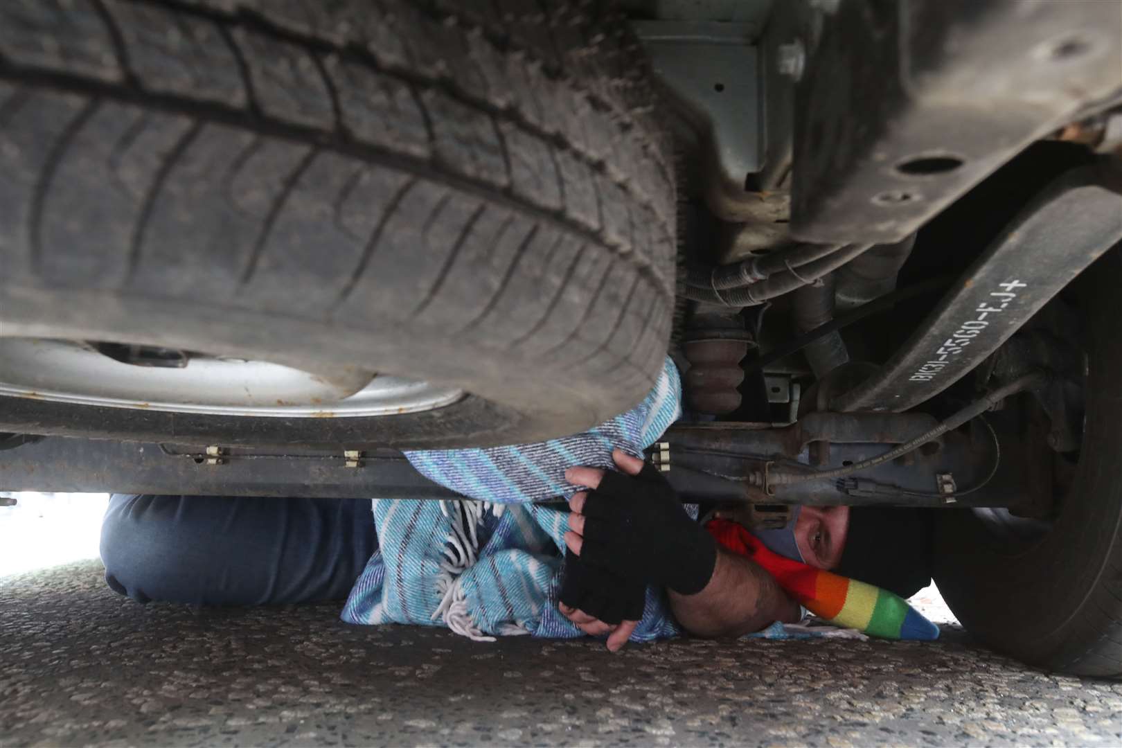 One person placed themselves underneath the immigration van to stop it moving (Andrew Milligan/PA)