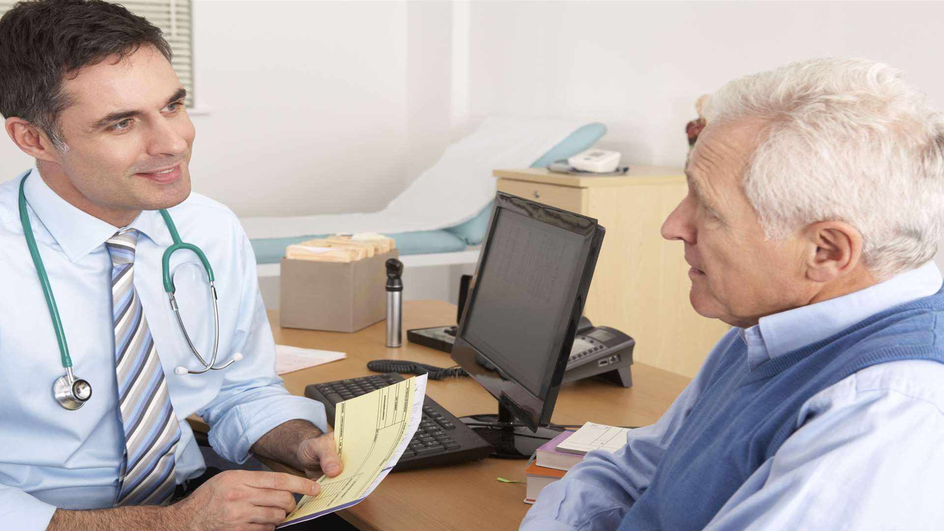 Stock picture of GP in a surgery with patient