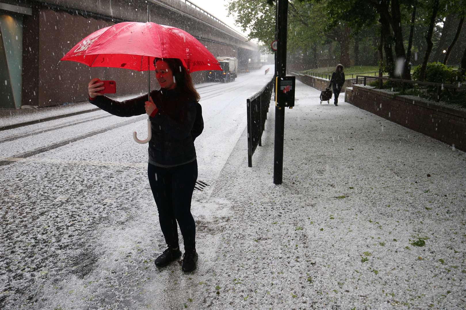 A woman takes a selfie in west London during a hail storm (Jonathan Brady/PA)