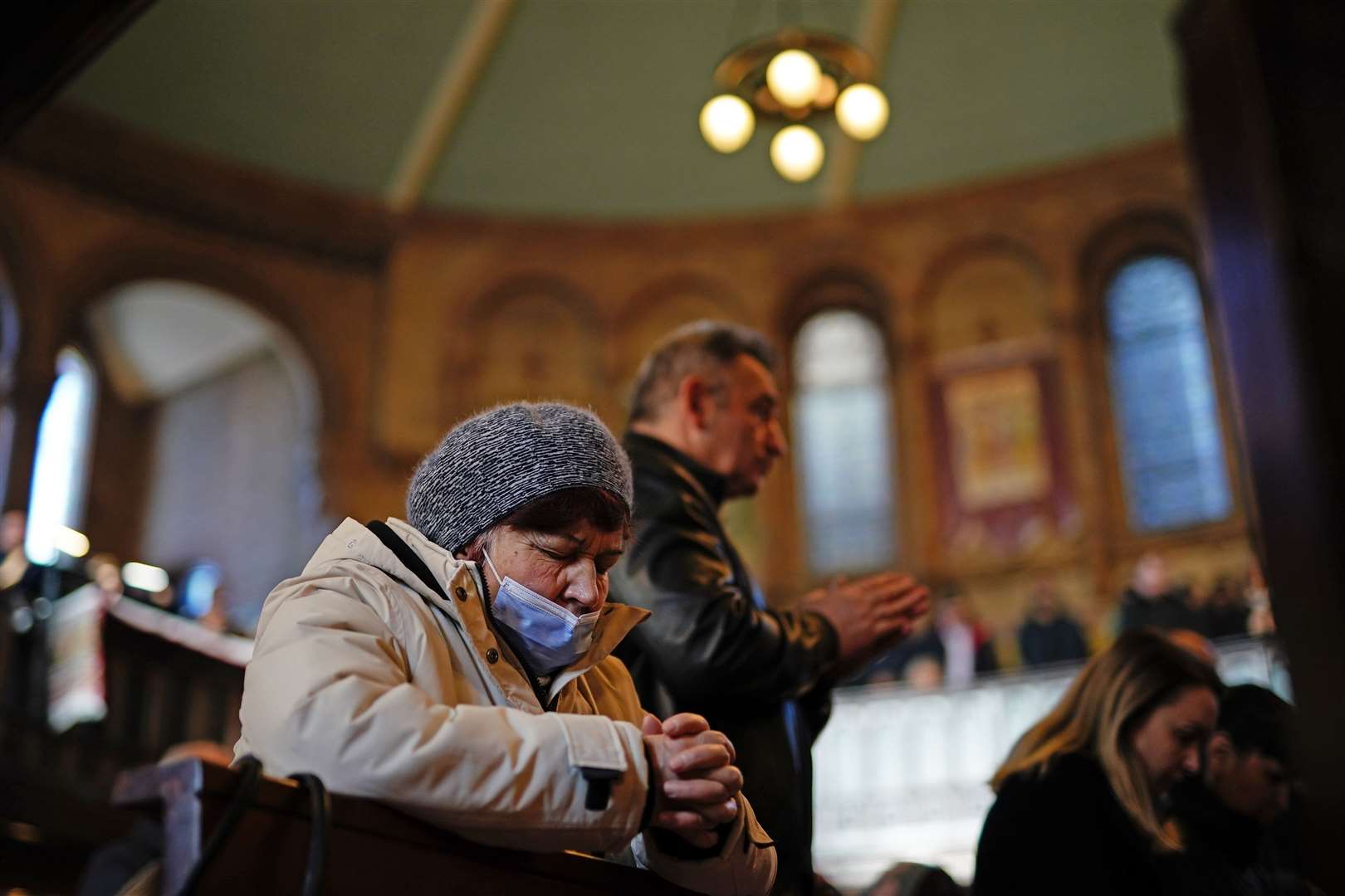 Members of the congregation pray at the service (Aaron Chown/PA)