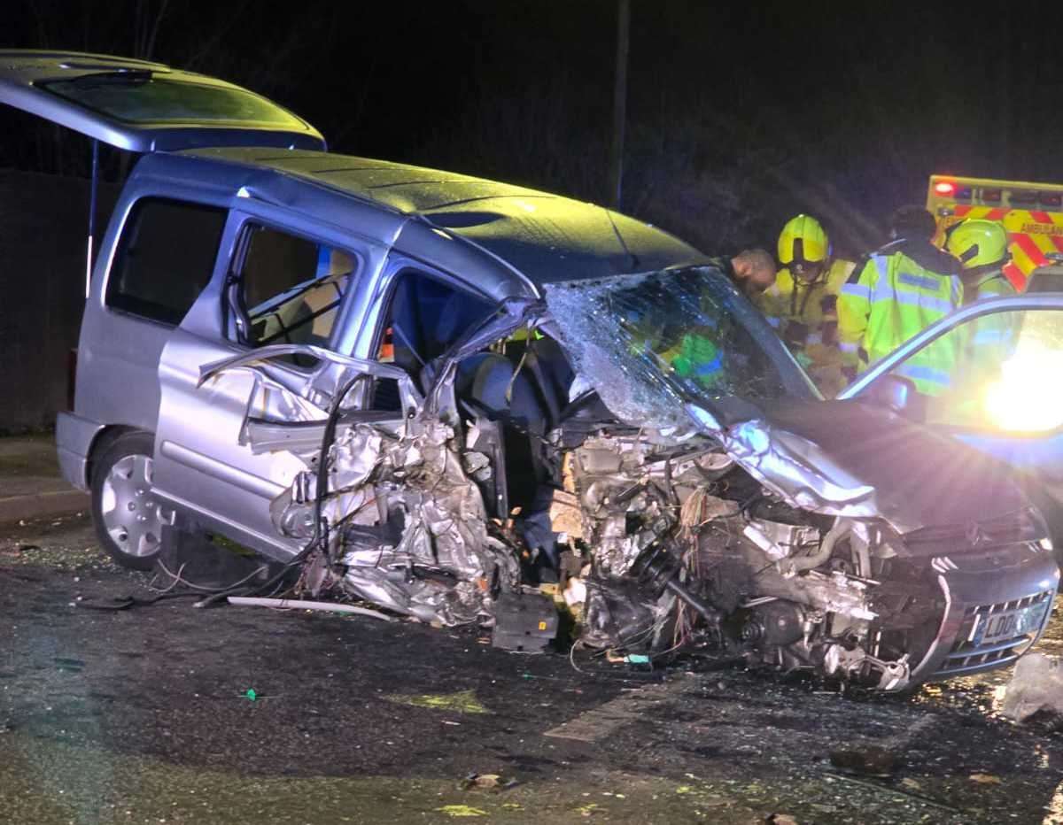 A woman had to be cut free from the wreckage of her car after a head-on crash with a bus