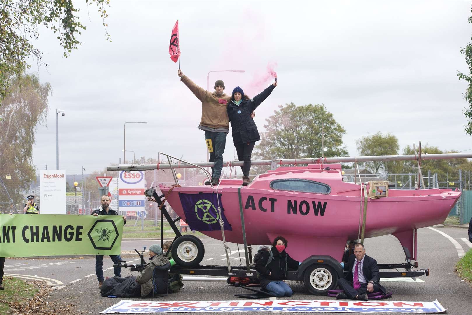 British Olympians Laura Baldwin and Etienne Stott outside ExxonMobil’s Fawley Oil terminal in Hampshire, calling for an end to use of fossil fuels and a stop to expansion plans for the site (Extinction Rebellion/PA)