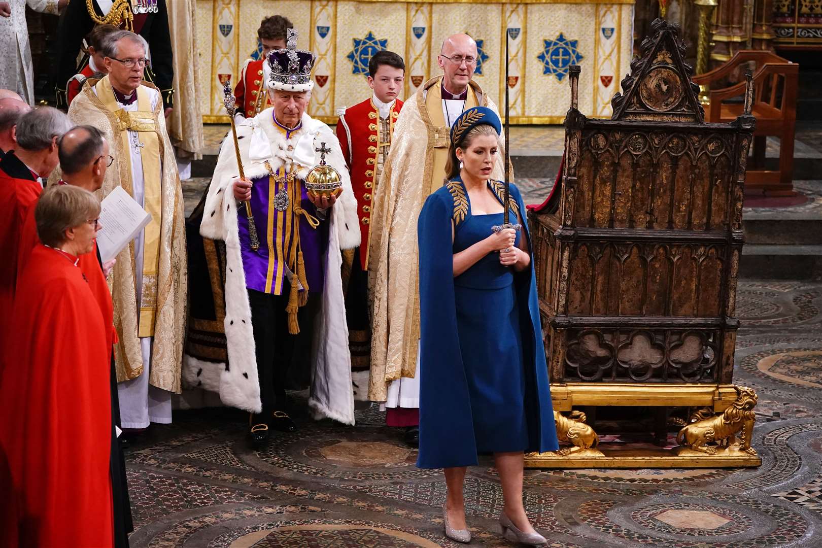 Lord President of the Council Penny Mordaunt holding the Sword of State walks ahead of the King in Westminster Abbey (Yui Mok/PA)