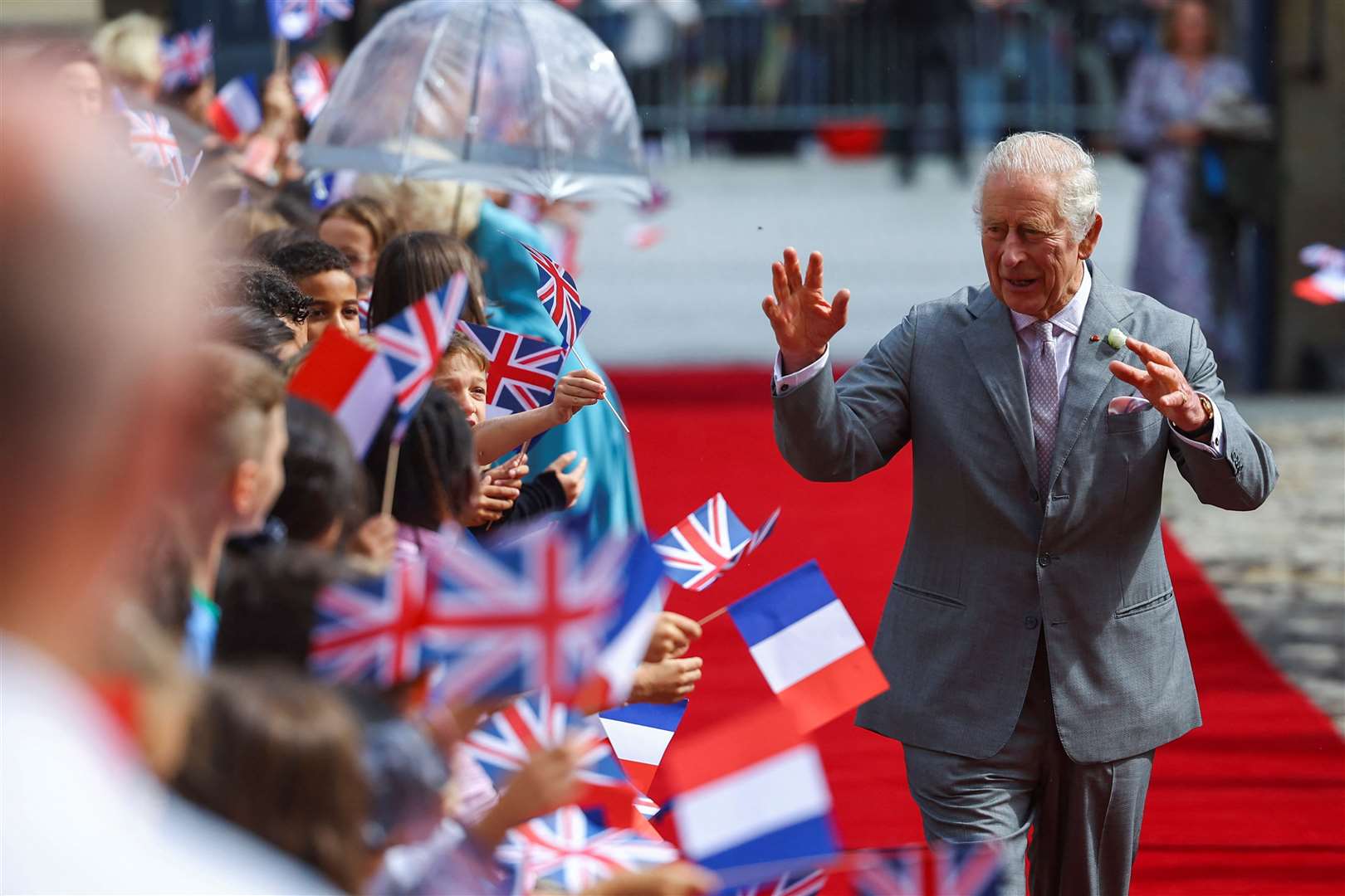 Charles was met by huge cheering crowds, waving French and Union flags (Hannah McKay/PA)