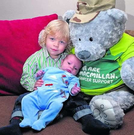 Baby Henry with brother Lewis and the raffle teddy their dad won