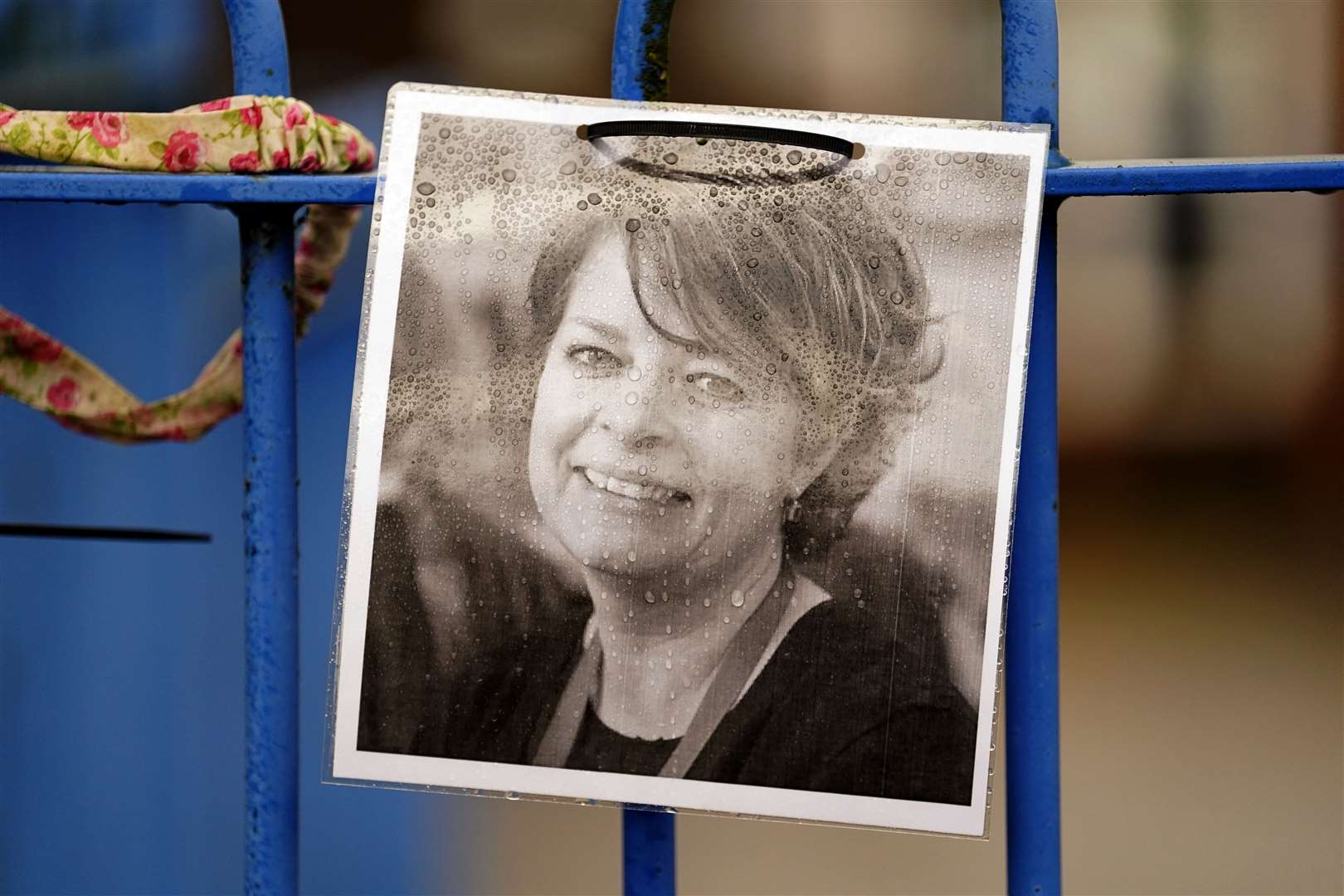 A photograph of Ruth Perry attached to the fence outside John Rankin Schools in Newbury, Berkshire, where headteacher Flora Cooper planned to refuse entry to Ofsted inspectors in March. She later reversed her decision (PA)