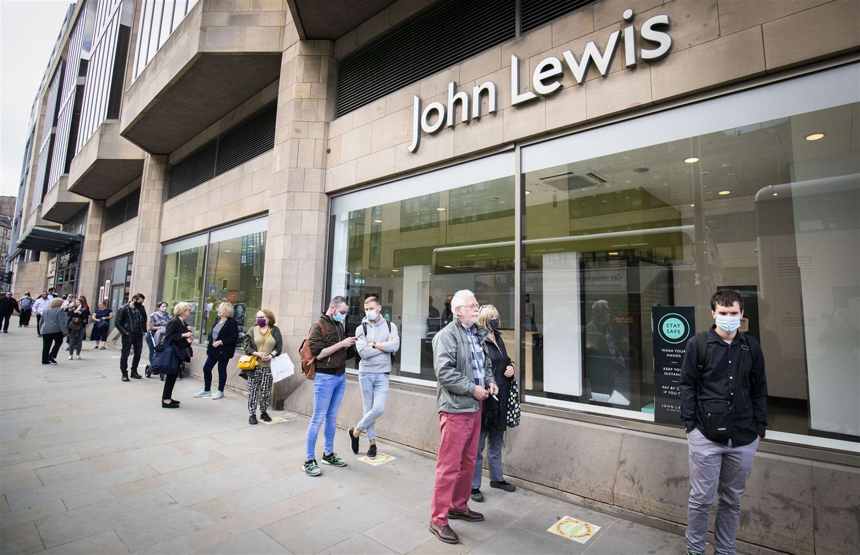 People queued outside the John Lewis department store in Edinburgh after it reopened last month (Jane Barlow/PA)