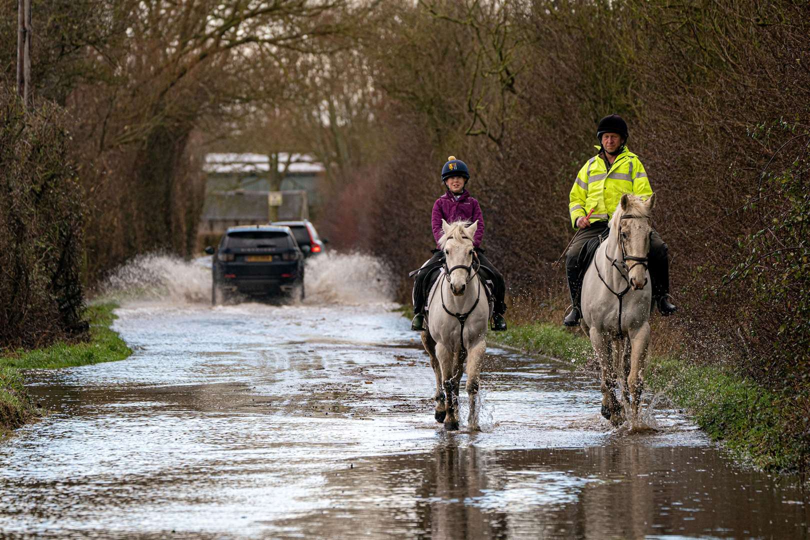 Horses and riders make their way through floodwater near Muchelney, Somerset (Ben Birchall/PA)