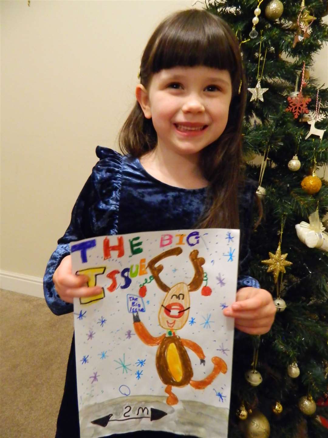 Evelyn with her cover-winning design (Big Issue)