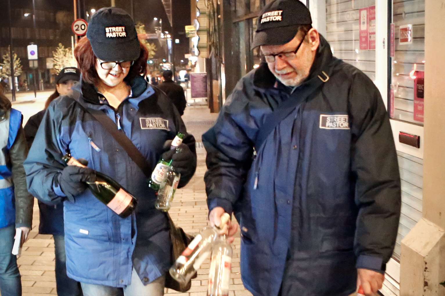 Street pastors Michelle and Tony Walsh collect up glass bottles