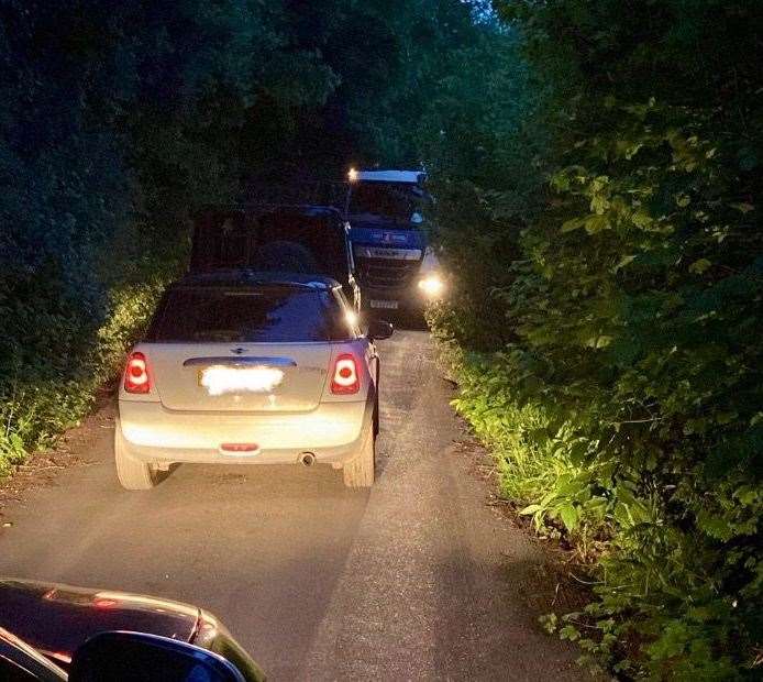 Queues building as a lorry and car cannot pass each other in Walnut Hill Road, Istead Rise