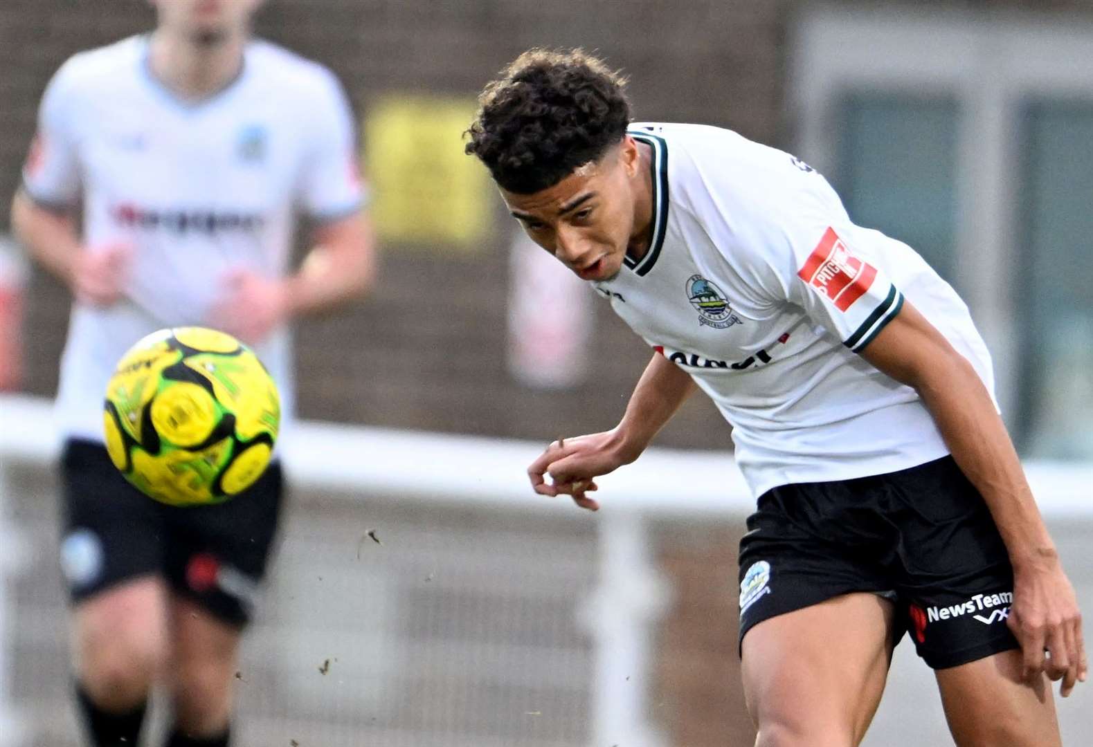 Luke Baptiste sends the ball forward for Dover. Picture: Barry Goodwin