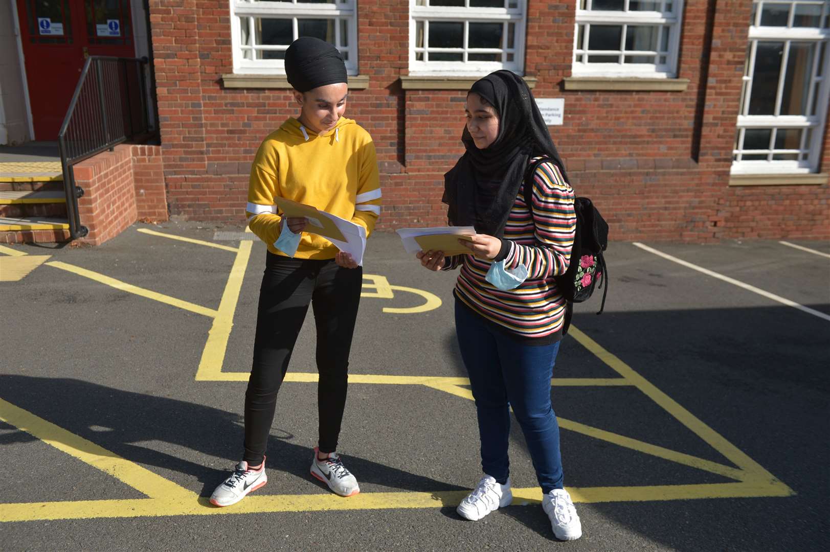 Simranjit Kaur (left) and Nayab Nasir open their results at Bristnall Hall Academy (Jacob King/PA)