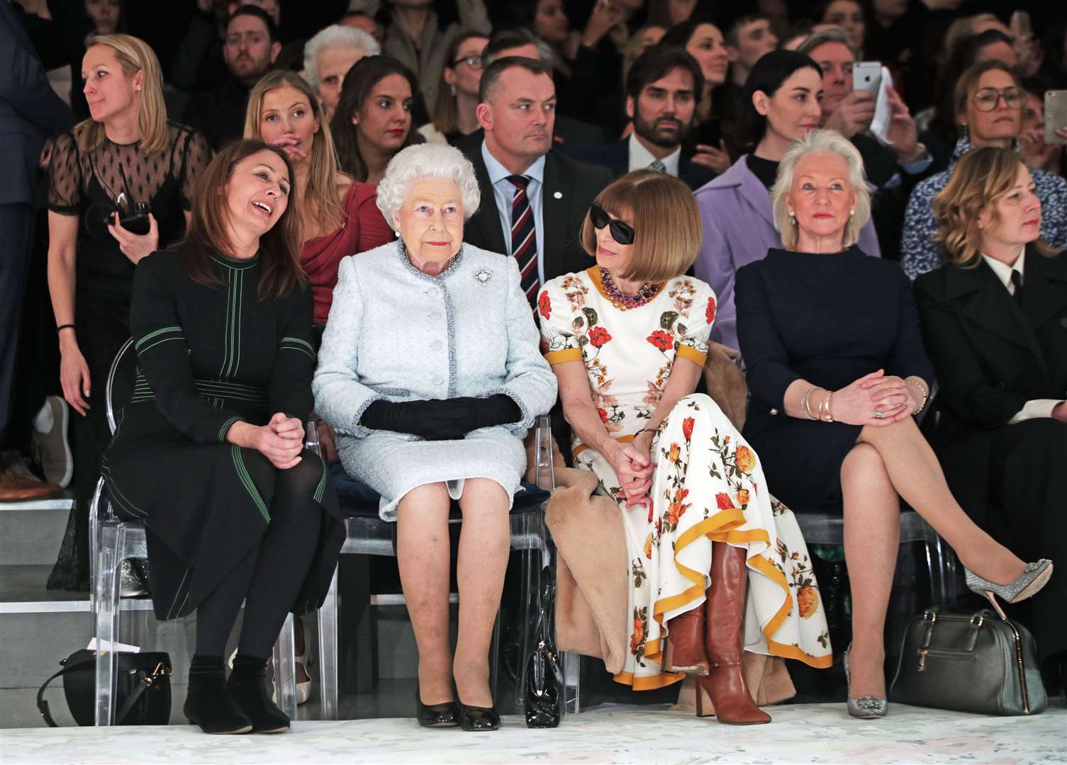 The Queen watches a fashion show with Caroline Rush, Dame Anna Wintour and Angela Kelly (Yui Mok/PA)