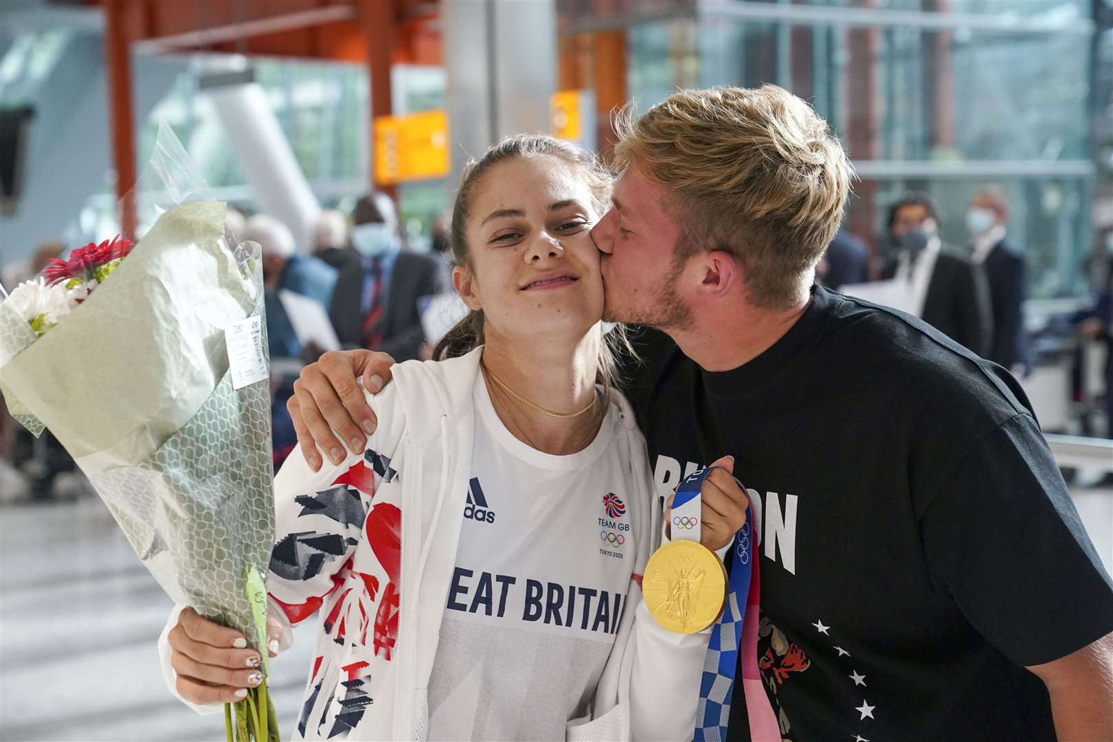 Gold medal winning BMX rider Bethany Shriever is met by her boyfriend Brynley Savage on her return to the UK (Steve Parsons/PA)