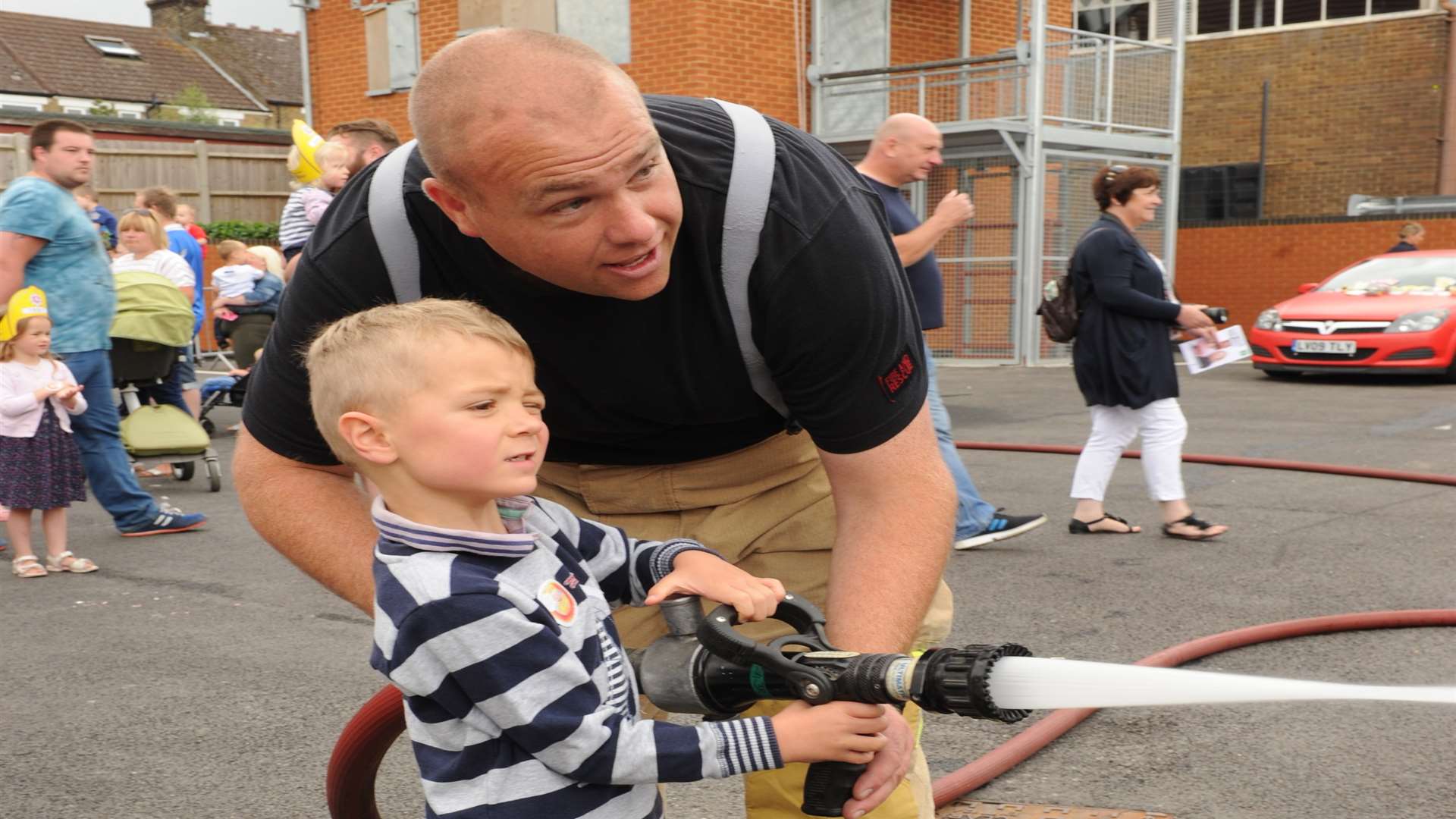 Firefighter Ben Thurston with Thomas Adams aged four