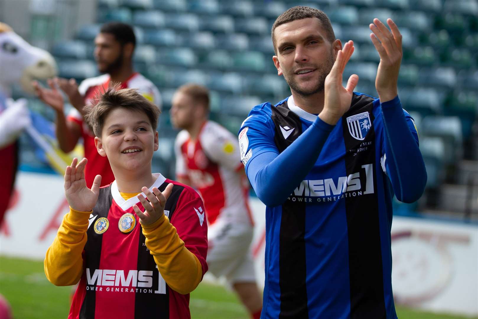 Daniel Lysak leads the Gillingham team out with captain Stuart O'Keefe. Picture: KPI