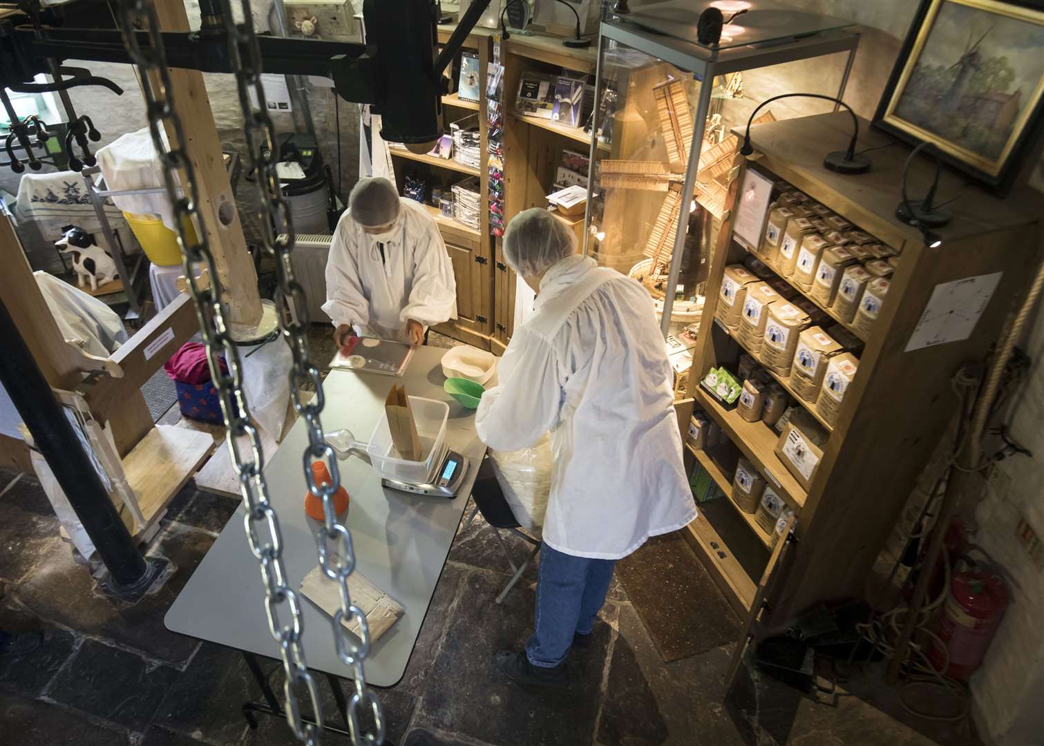 Flour is placed into bags inside the windmill (Danny Lawson/PA)