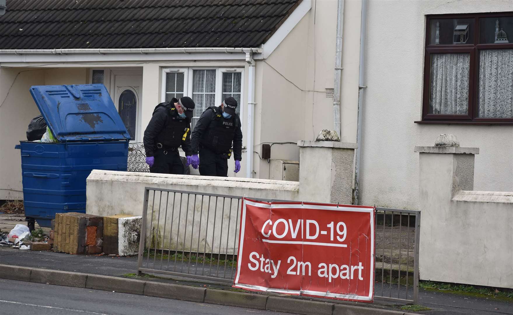 Police search the grounds of a nearby property (Matthew Cooper/PA)