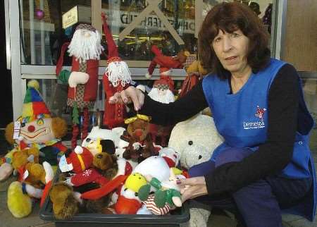 Volunteer Ruth Perrin with some of the glass and rain ruined stock. Picture: ANDY PAYTON