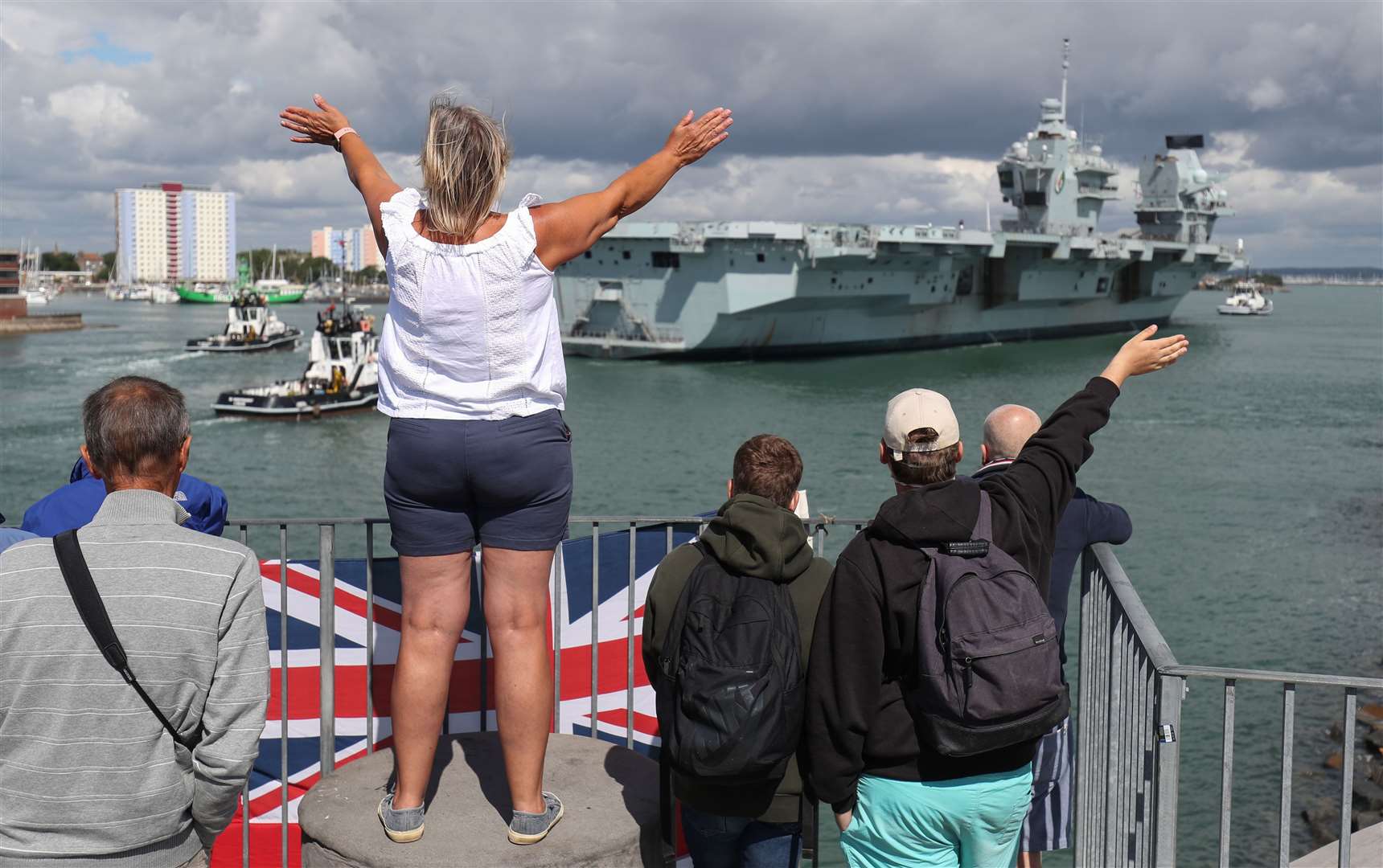 Relatives welcome HMS Queen Elizabeth back to Portsmouth Naval Base (Andrew Matthews/PA)