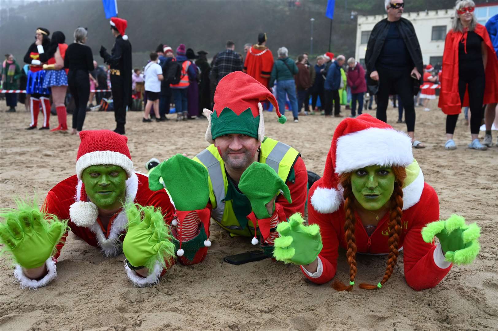 People take part in the annual Tenby Boxing Day swim dressed as superheroes (Gareth Davies Photography/Tenby Boxing Day Swim/PA)