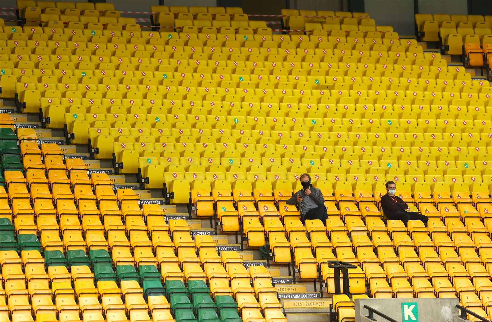 But there are still no crowds at the football as the empty stands at Norwich show (Richard Heathcote/NMC Pool/PA)