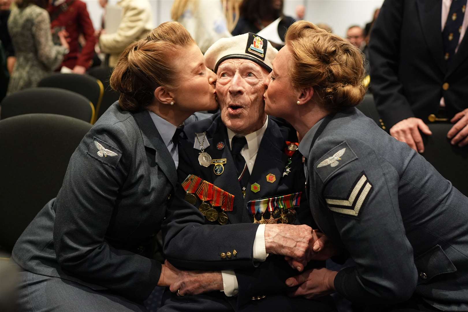 Mr Penstone receives a kiss from the D-Day Darlings at an event organised by the Spirit of Normandy Trust, in conjunction with the British Normandy Memorial, at the Union Jack Club in London (Gareth Fuller/PA)