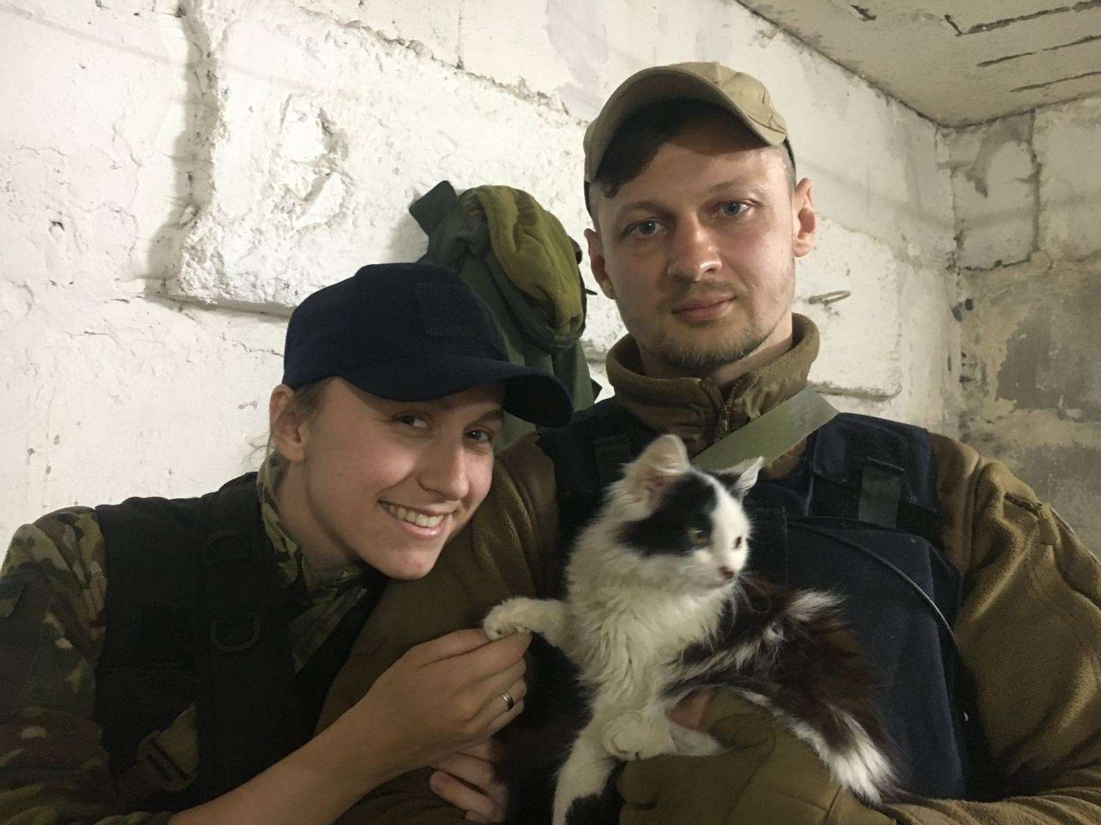 Oksana Krasnova (left), 27, and her husband Stanislav Krasnov, 35, holding a rescued cat (Oksana Krasnova/PA)