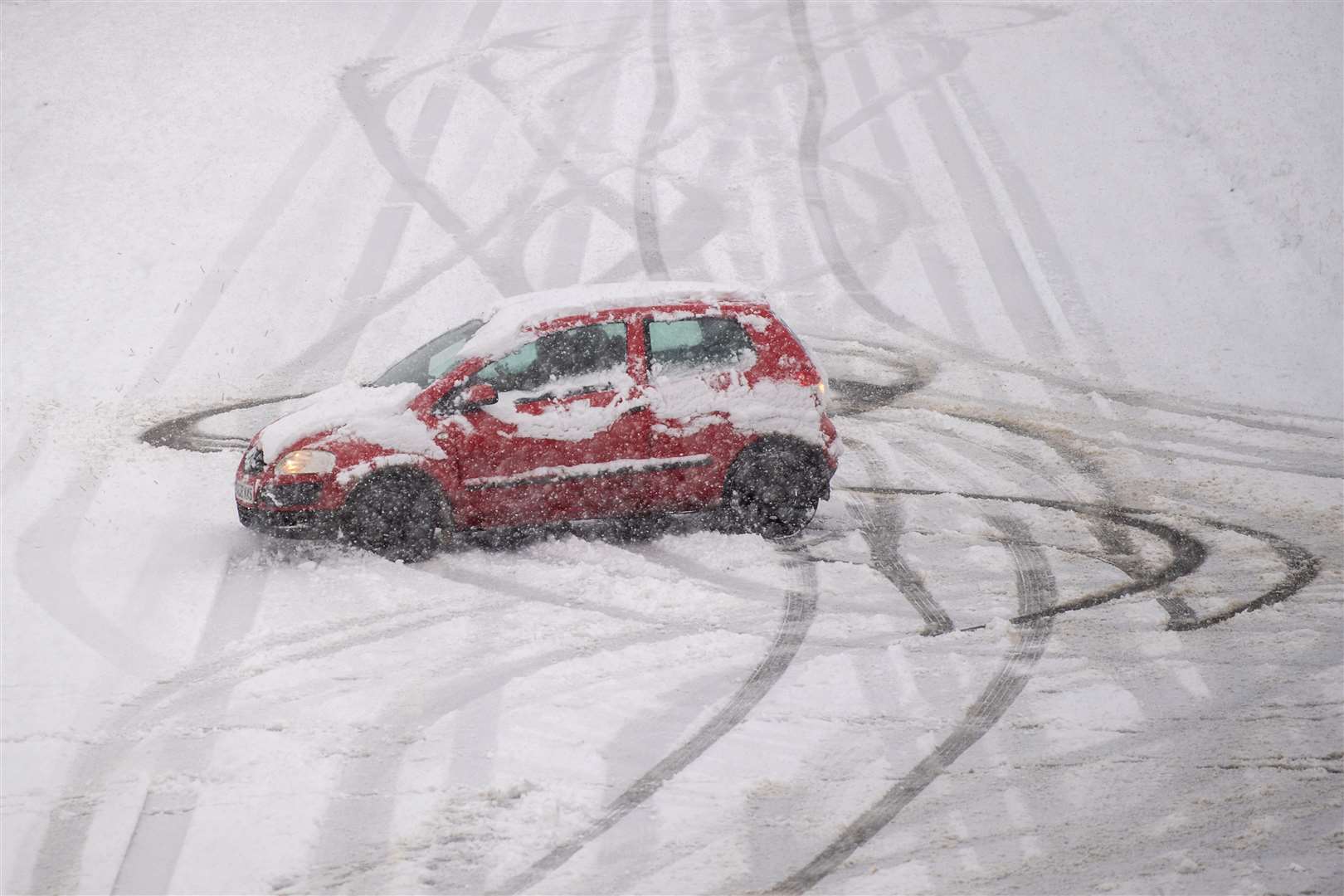 A car spins on a snow covered road near Mountsorrel in Leicestershire (Joe Giddens/PA)