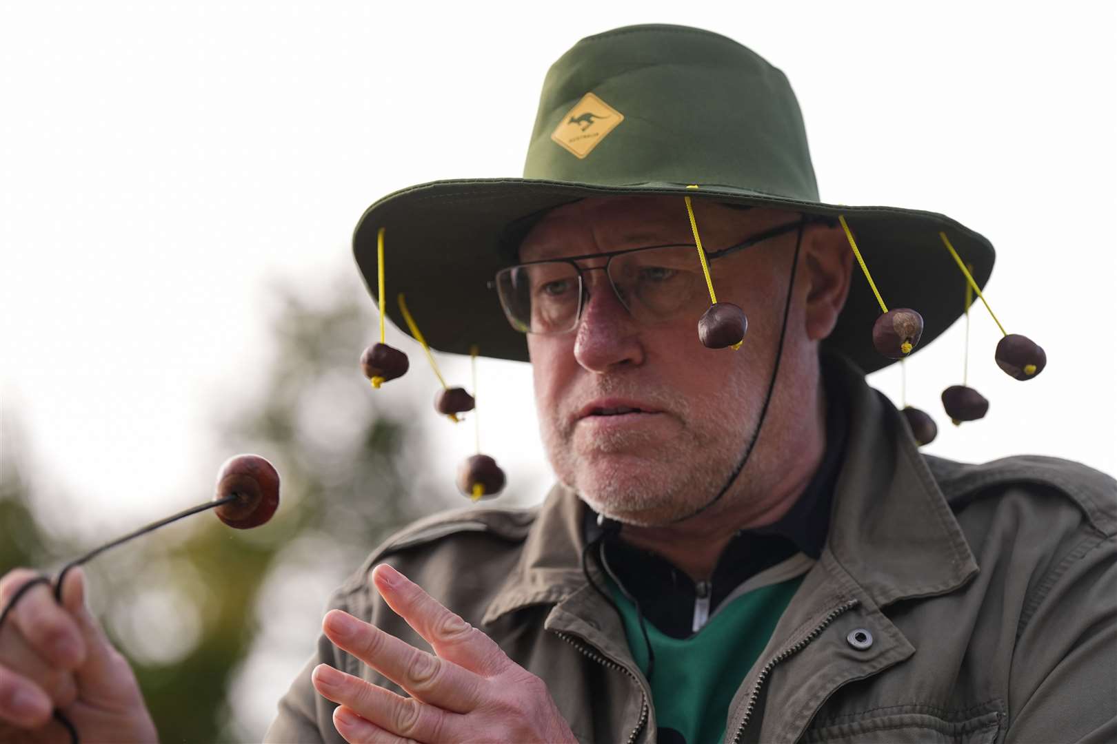 A competitor wearing a conker themed hat (Jacob King/PA)