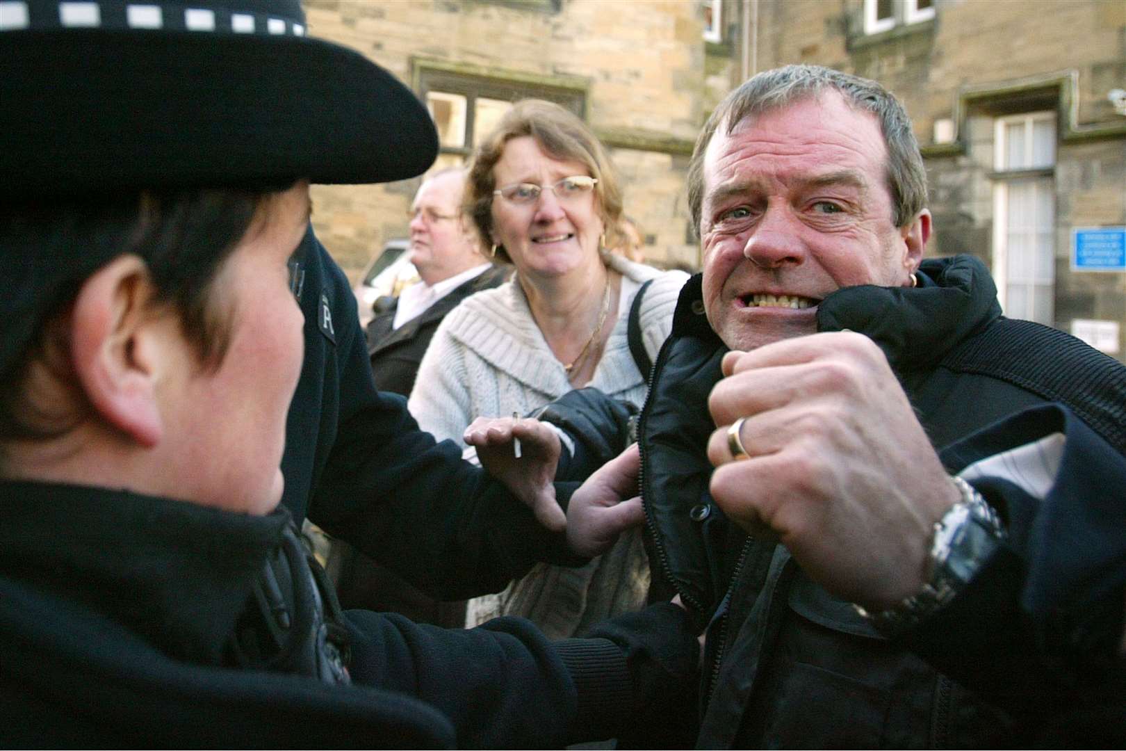 Vicky Hamilton’s father Michael is restrained by police as Peter Tobin leaves Linlithgow Sheriff Court in West Lothian in 2007 (Andrew Milligan/PA)