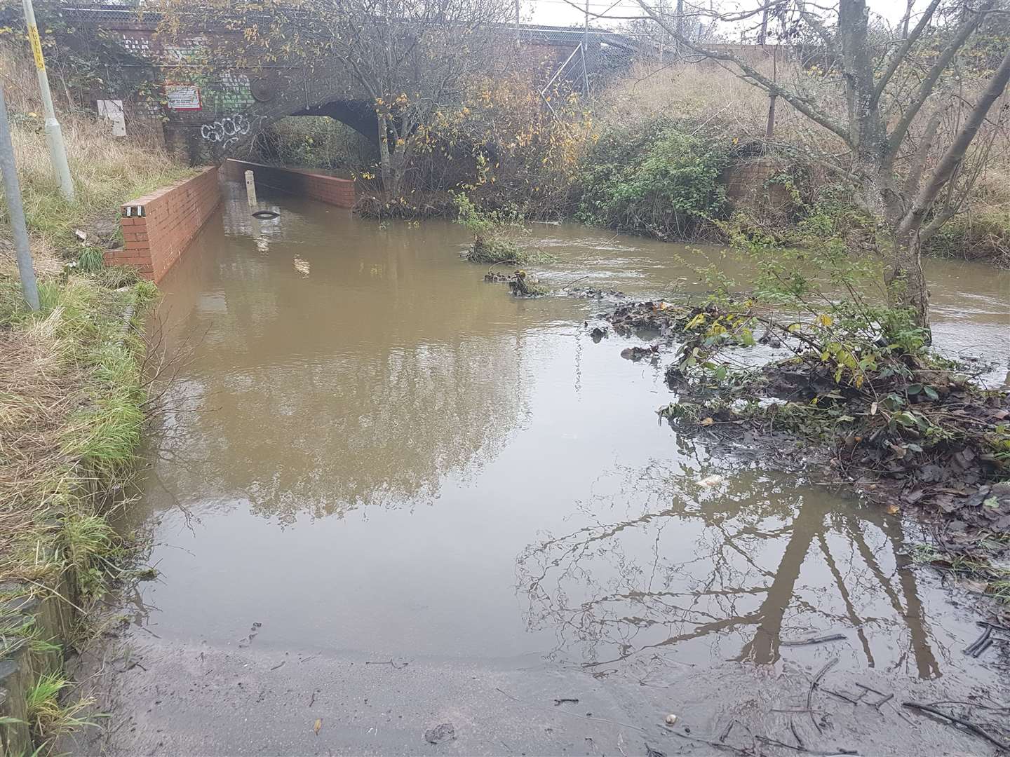 An underpass next to the car park has been completely cut off by water