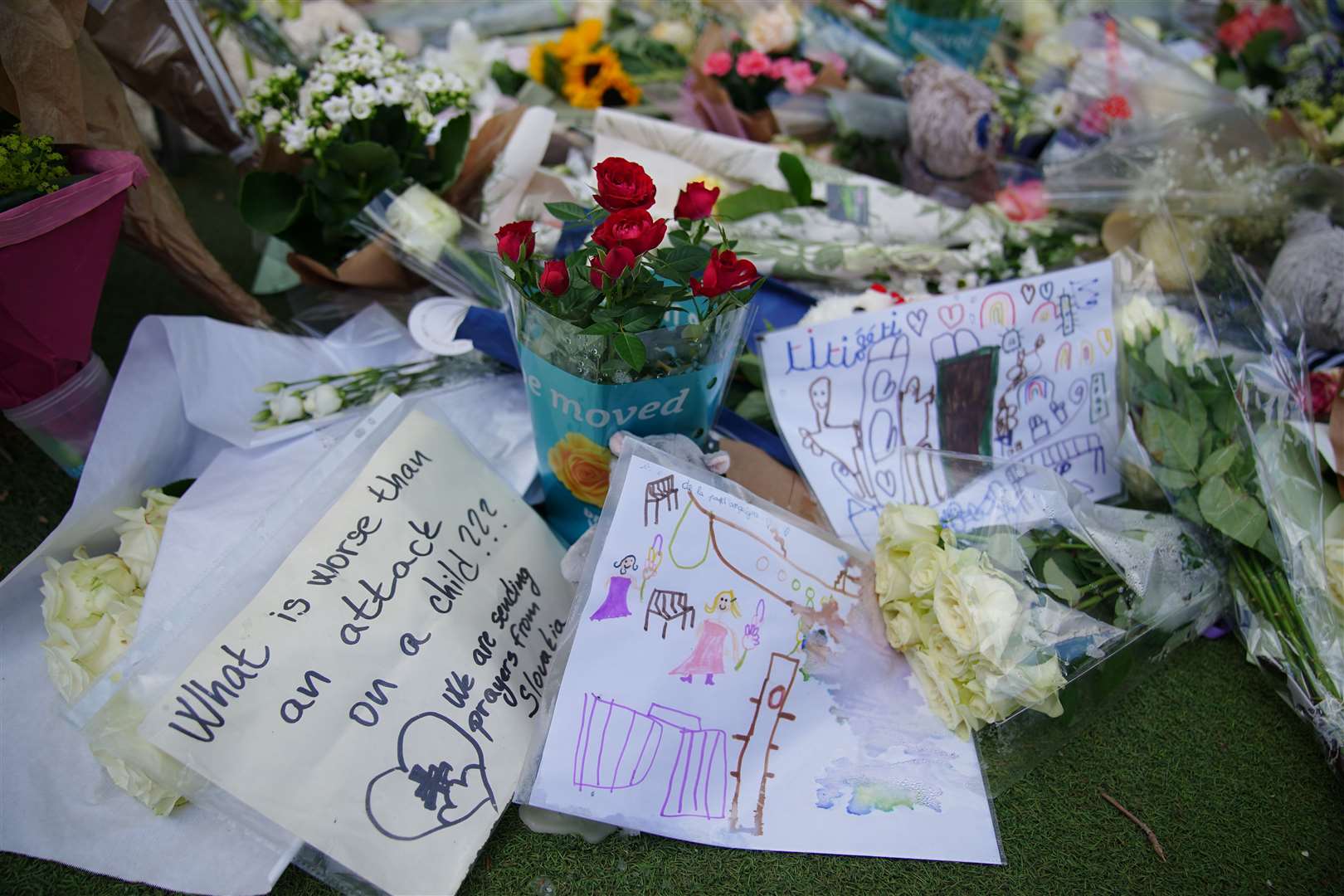 Flowers near the scene at a lakeside park in in Annecy, France, following a knife attack (Peter Byrne/PA)