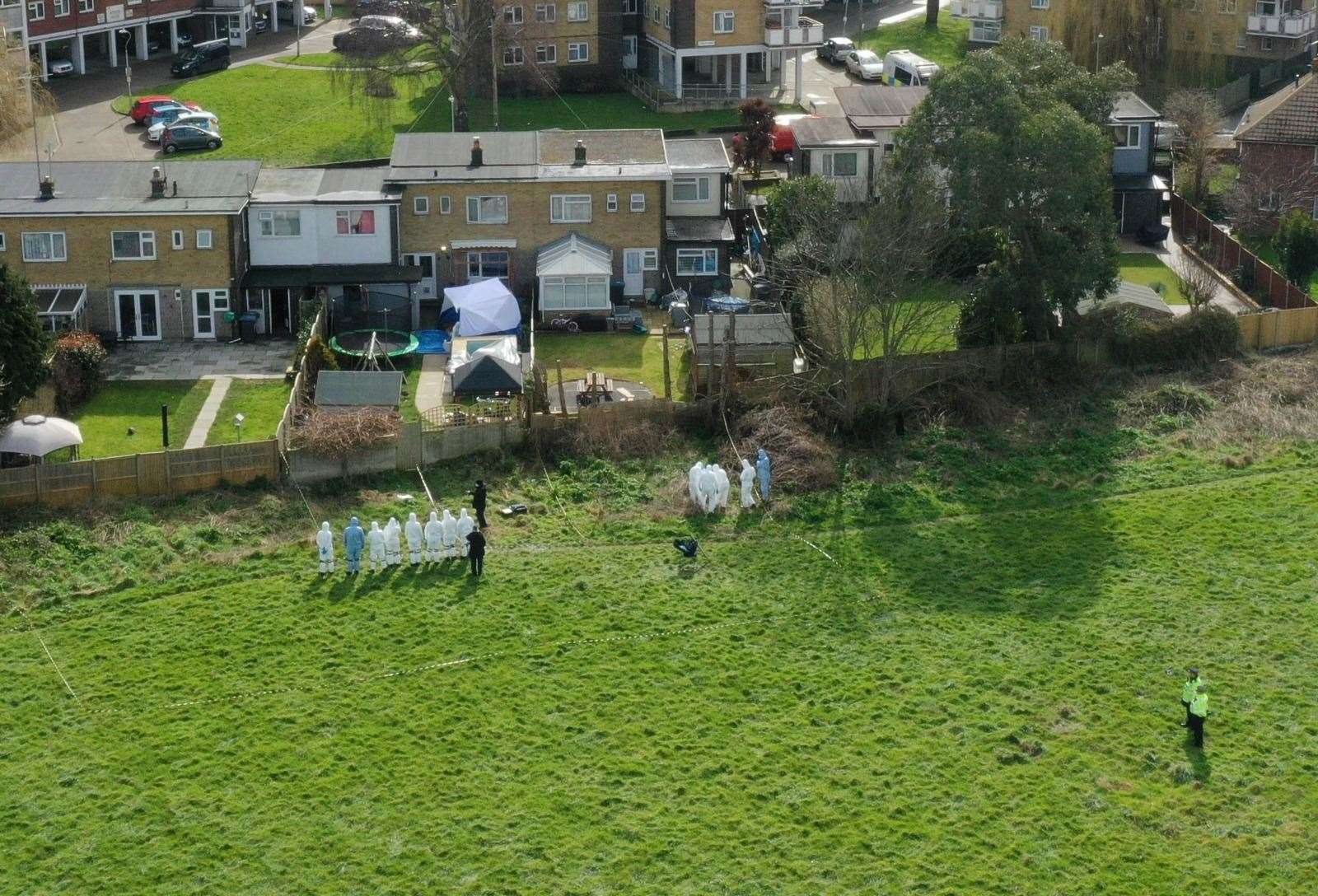 Forensics officers search fields that back on to Wayne Couzens' home Picture: UKNIP (51910495)