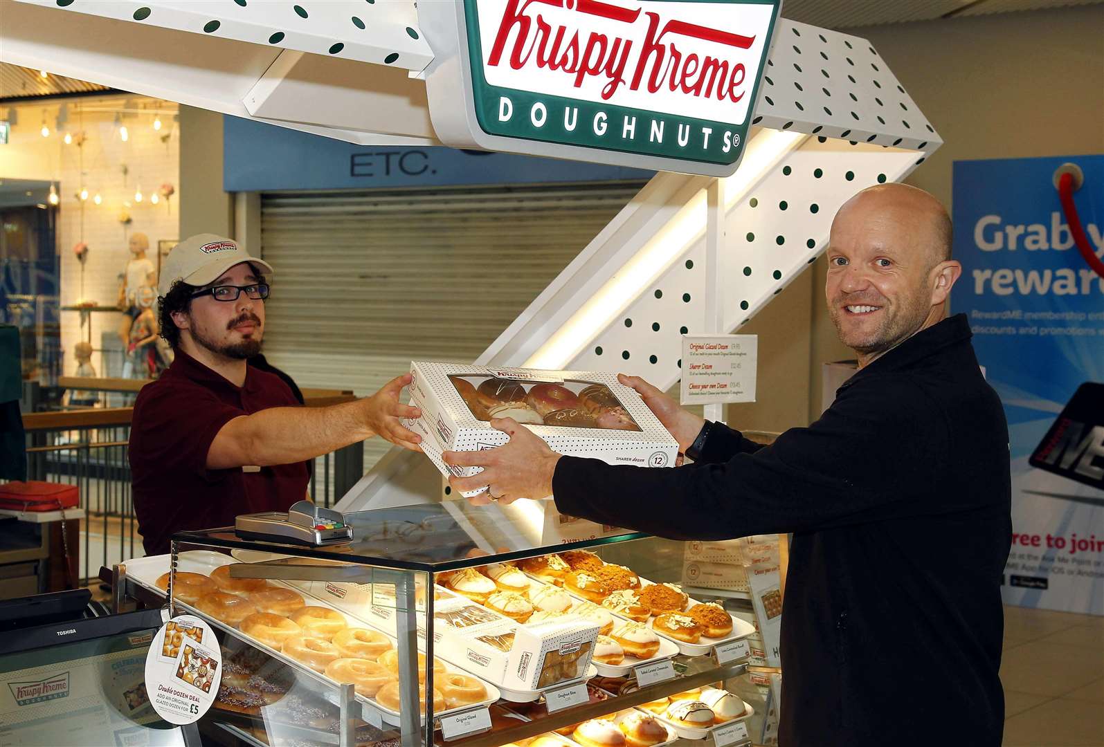 Krispy Kreme opens in the Mall MaidstoneFirst customer today is Mark Bidewell, served by Andrew Boyce.Picture: Sean Aidan (2168986)