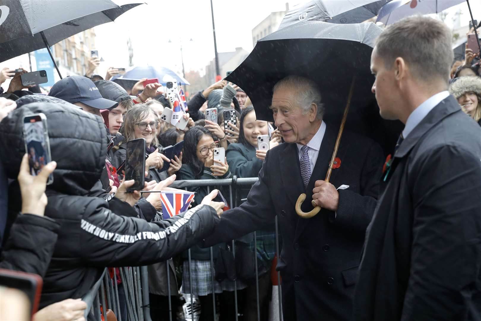 Charles greeted fans, who waited for him in the rain during his visit to New Malden (John Phillips/PA)