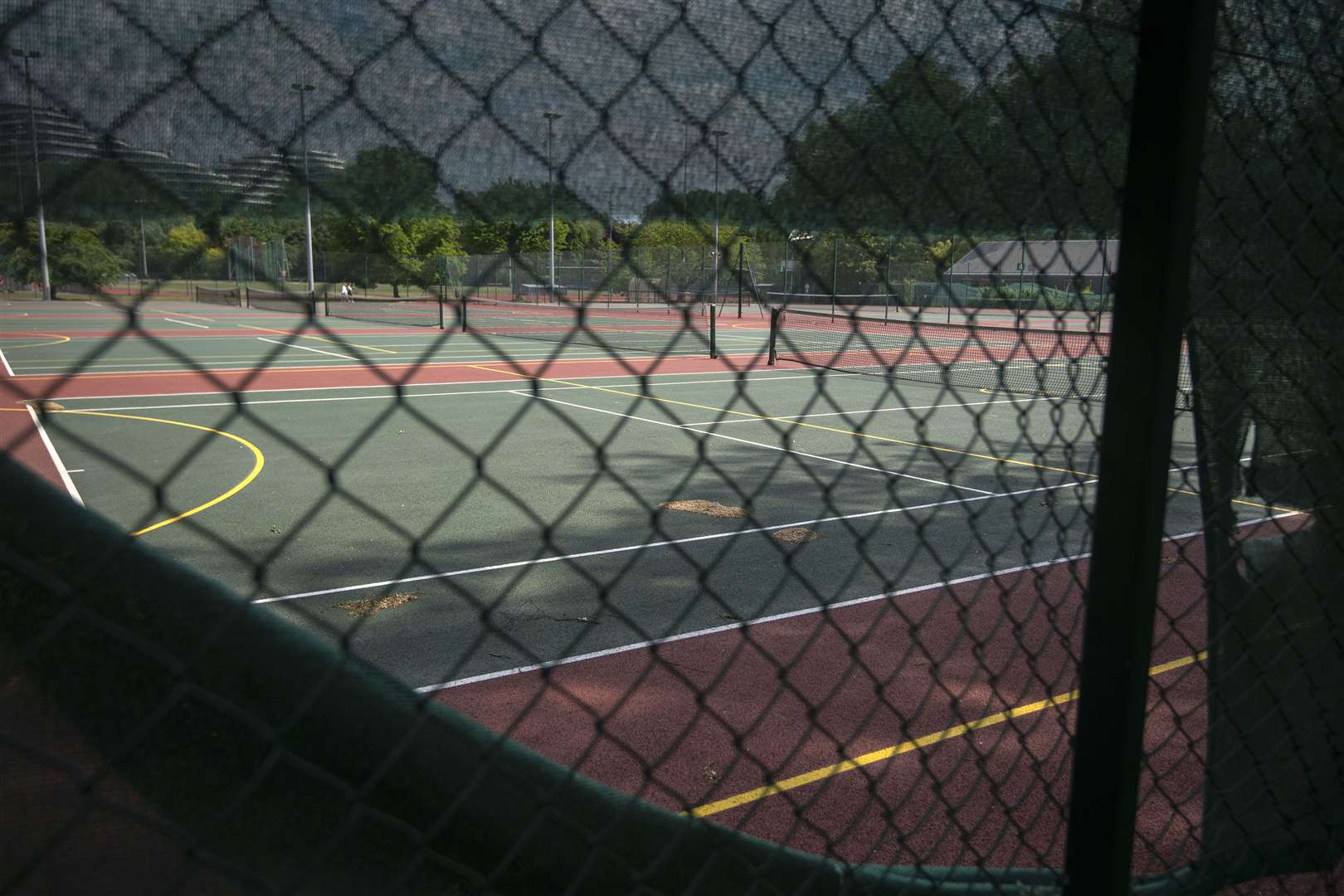 Tennis courts remain locked and empty in May in Battersea Park, London (Victoria Jones/PA)