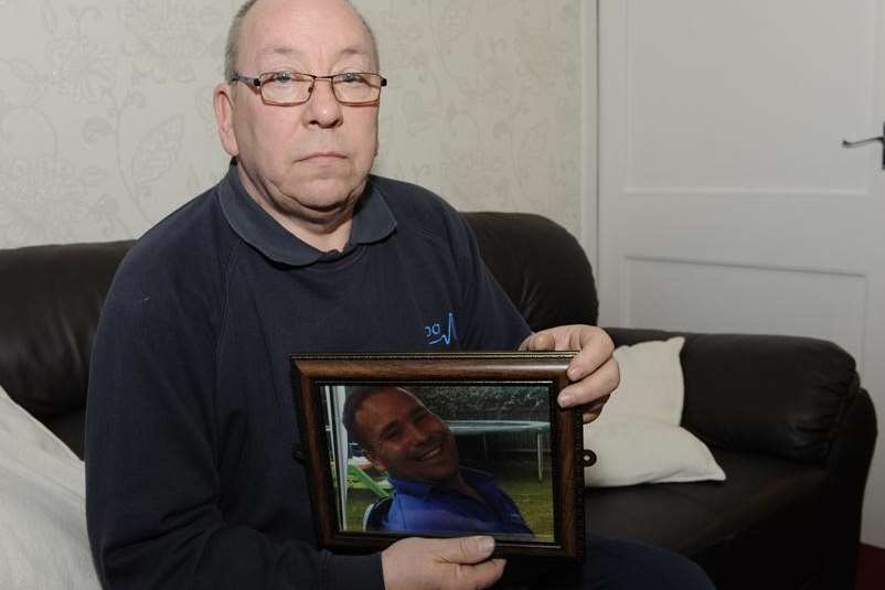 Lester Tennyson Smith with a picture of his son Mark