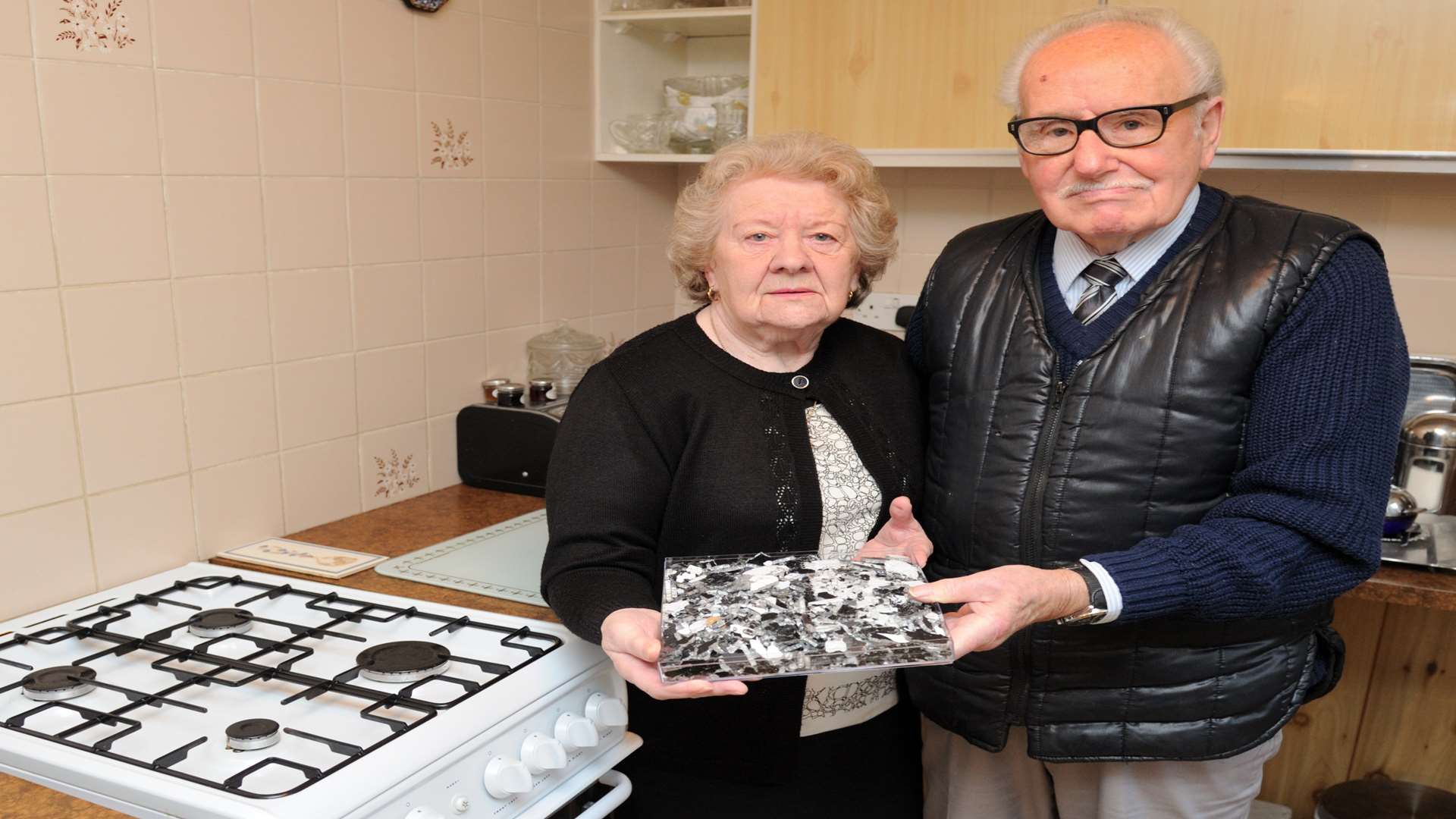 Monica and Wally Williams with pieces of glass from the oven that exploded