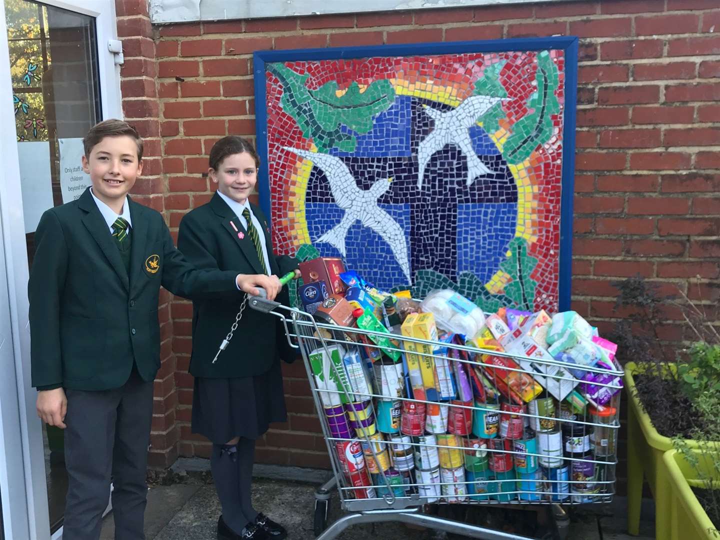 Lucy and Philip, head girl and head boy at Platt School with their food collection