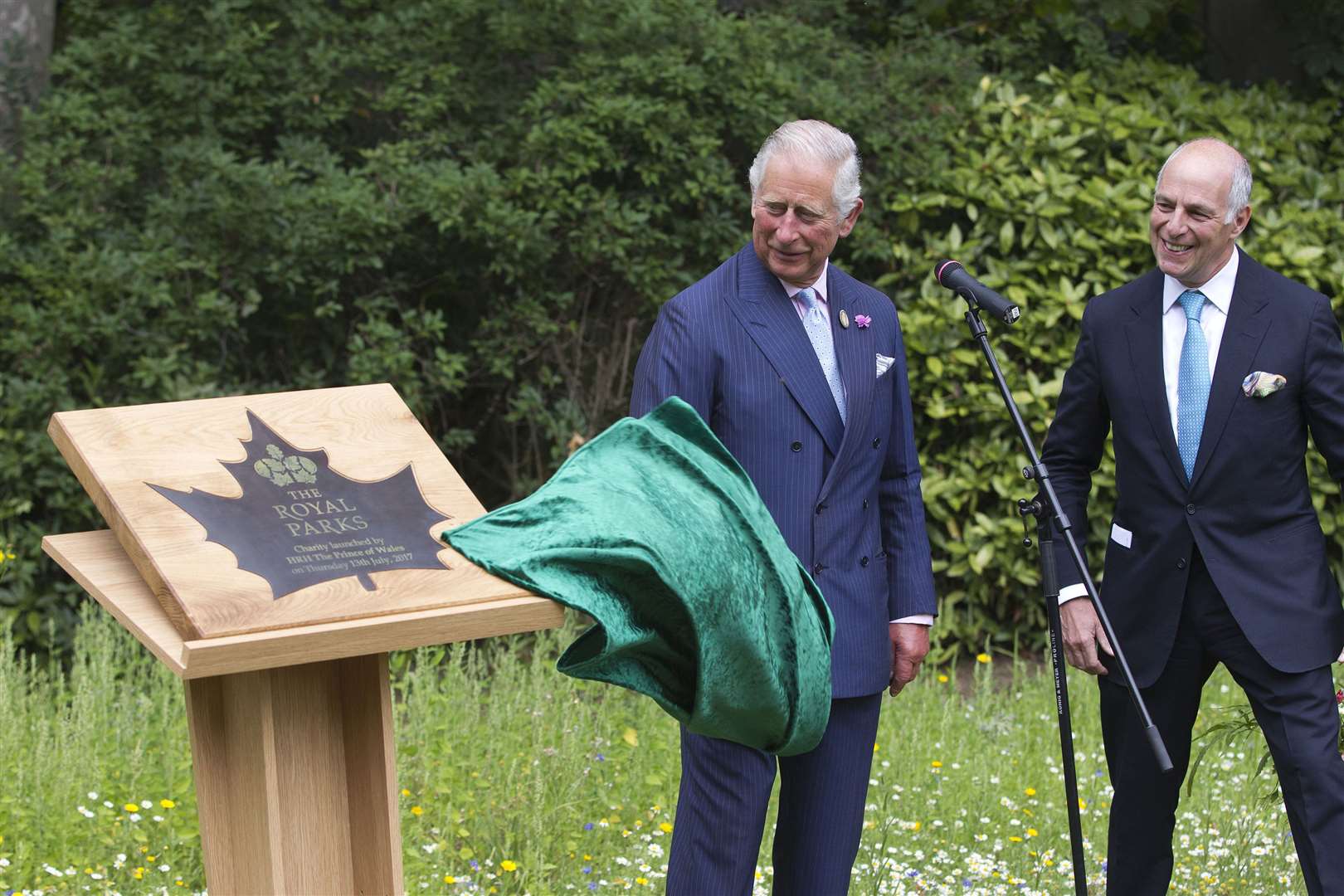 Charles unveiling a plaque with Loyd Grossman as he launches the new Royal Parks charity in Hyde Park, London (Jeff Gilbert/The Daily Telegraph)