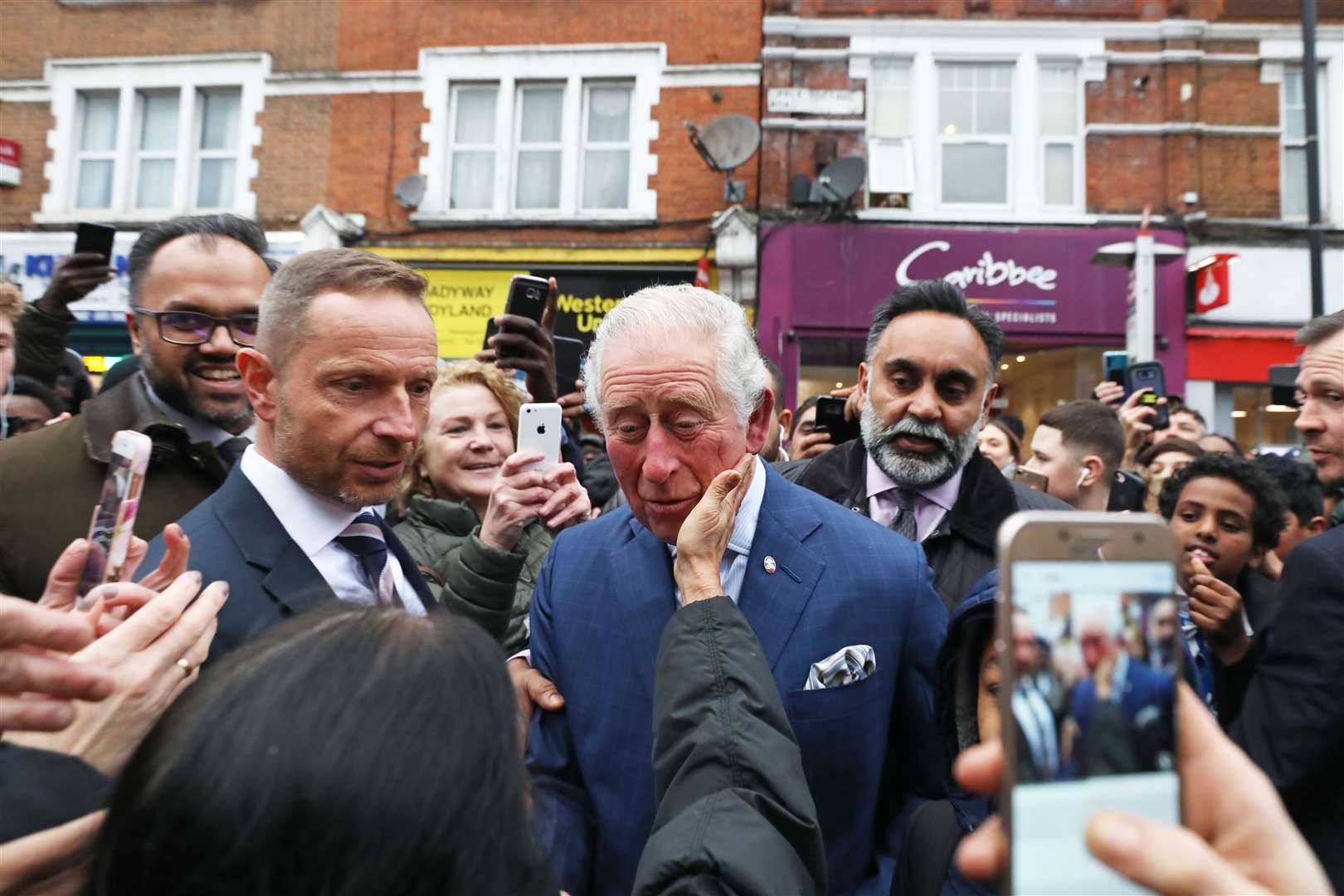 The Prince of Wales is greeted by members of the public as he leaves a TK Maxx store on Tooting High Street, London, in February (Philip Toscano/PA)